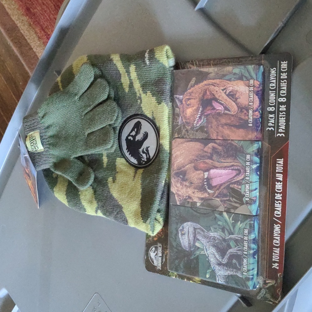 Jurassic world hat and glove set and three boxes of Jurassic Park crayons. NWT